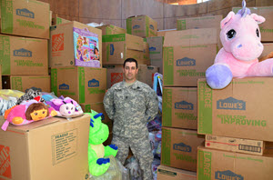 Texas State Guard Staff Sgt. Williams, 1st Battalion, 2nd Regiment, stands amongst donated toys at Dell's Children Hospital in Austin, Texas, Dec. 19, 2015, as part of the annual "Young Heroes of the Guard" program. Williams led toy drive operations for 1st Battalion, 2nd Regiment and collected more than 25,000 toys to be delivered to sick children all over Texas. (Texas State Guard photo by Col. Joseph Jelinski/ Released)
